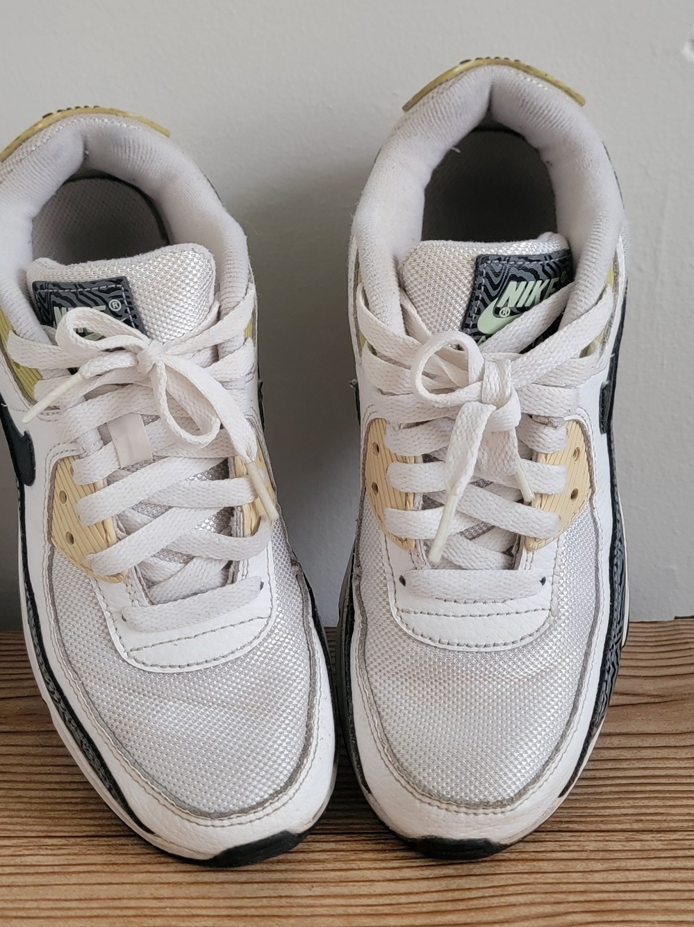 Nike Kids' White and Black Athletic Shoes with Gold Accents